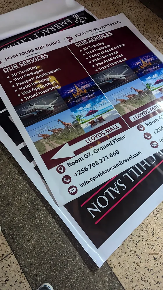 Printed travel agency flyers laid out on a shop floor.