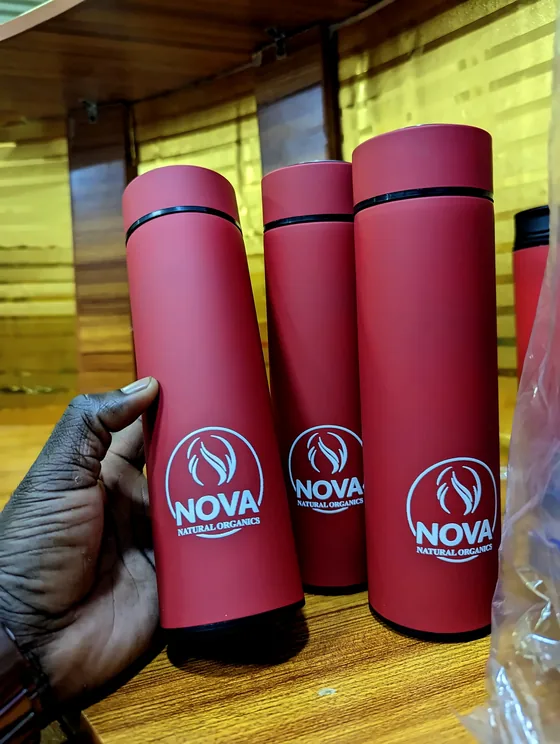Three red flasks printed with the white NOVA Natural Organics logo.
