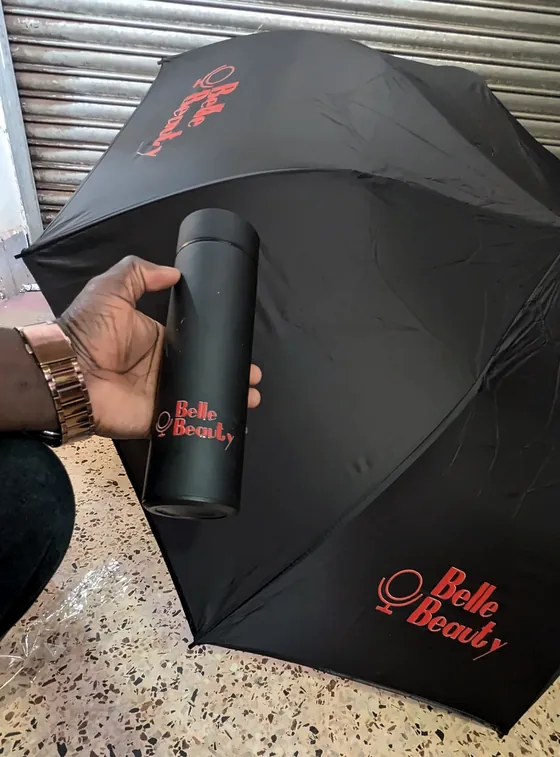 Black umbrella and black flask with red script branding.